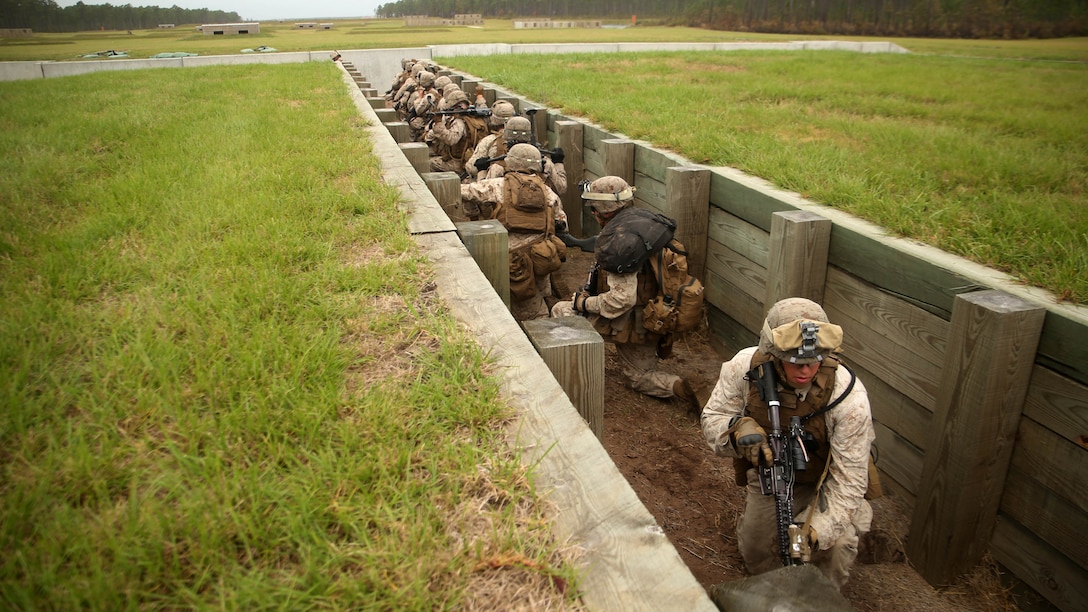 Marines with 1st Battalion, 6th Marine Regiment, prepare to take a support by fire position during a platoon-reinforced attack at Marine Corps Base Camp Lejeune, N.C., Oct. 28, 2015. “To get to this point in training we went with the ‘crawl, walk, then run’ idea. Before this training we did a squad reinforced maneuver range to make sure our guys understood it at that level before moving up,” said 1st Lt. Mark Dela Pena, a platoon commander with the unit. The battalion is conducting this training as they prepare to deploy on the 22nd Marine Expeditionary Unit next year.
