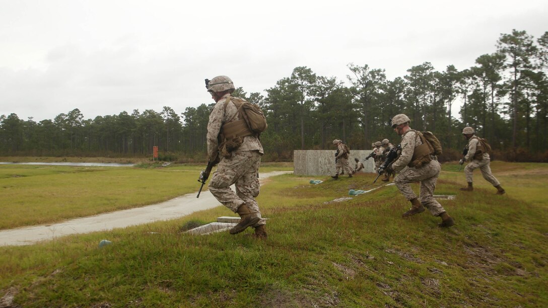 Marines with 1st Battalion, 6th Marine Regiment, assault an objective during a platoon-reinforced attack at Marine Corps Base Camp Lejeune, N.C., Oct. 28, 2015. The battalion is conducting this training as they prepare to deploy on the 22nd Marine Expeditionary Unit next year.
