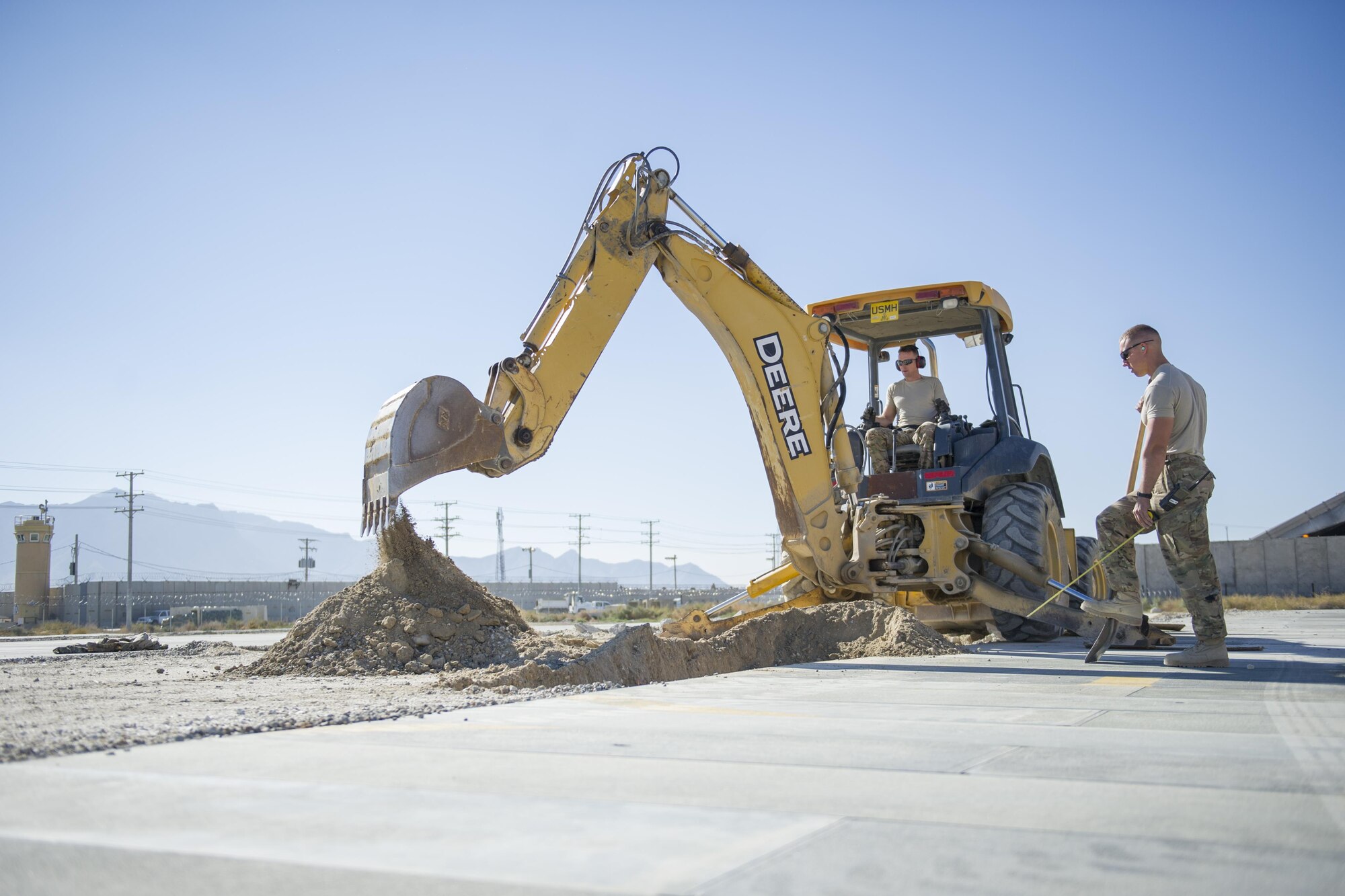 Tech. Sgt. David Blankenship and Airman 1st Class Patrick Chuba, 455th Expeditionary Civil Engineer Squadron pavements and equipment technicians deployed from Barksdale Air Force Base, La., work on a contruction project at Bagram Airfield, Afghanistan, Nov. 4, 2015. The 455th ECES "Dirt Boys" prepared an area for cement in support of a large- area maintenance structure slated for construction in the next few months.(U.S. Air Force photo by Tech. Sgt. Robert Cloys/RELEASED)