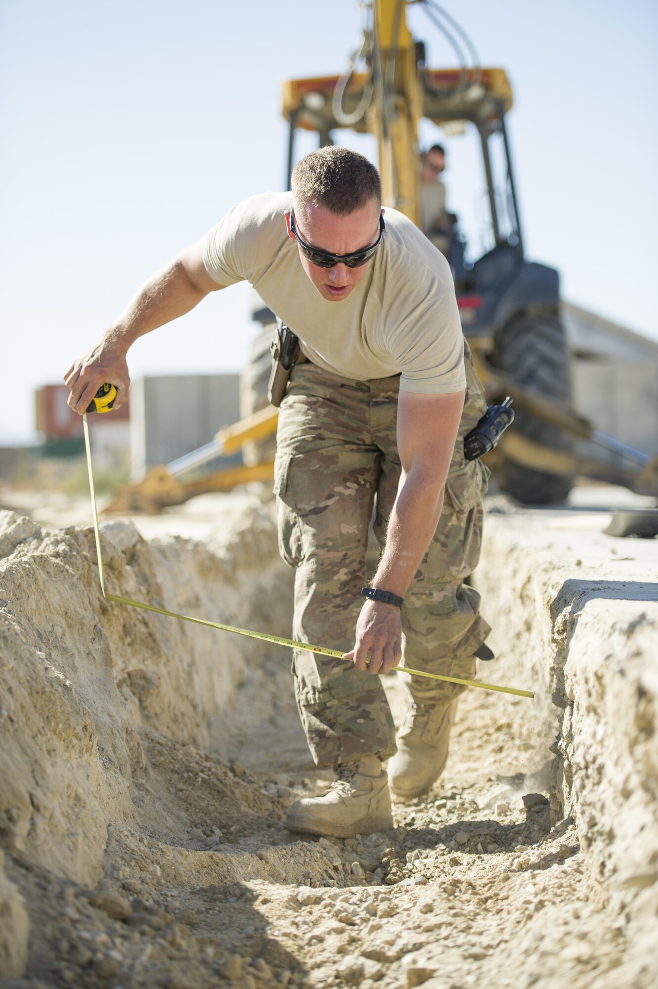 Airman 1st Class Patrick Chuba, 455th Expeditionary Civil Engineer Squadron pavements and equipment technician, deployed from Barksdale Air Force Base, La., measures a construction site at Bagram Airfield, Afghanistan, Nov. 4, 2015. The 455th ECES "Dirt Boys" prepared an area for cement in support of large-area maintenance structure slated for construction in the next few months.(U.S. Air Force photo by Tech. Sgt. Robert Cloys/RELEASED)