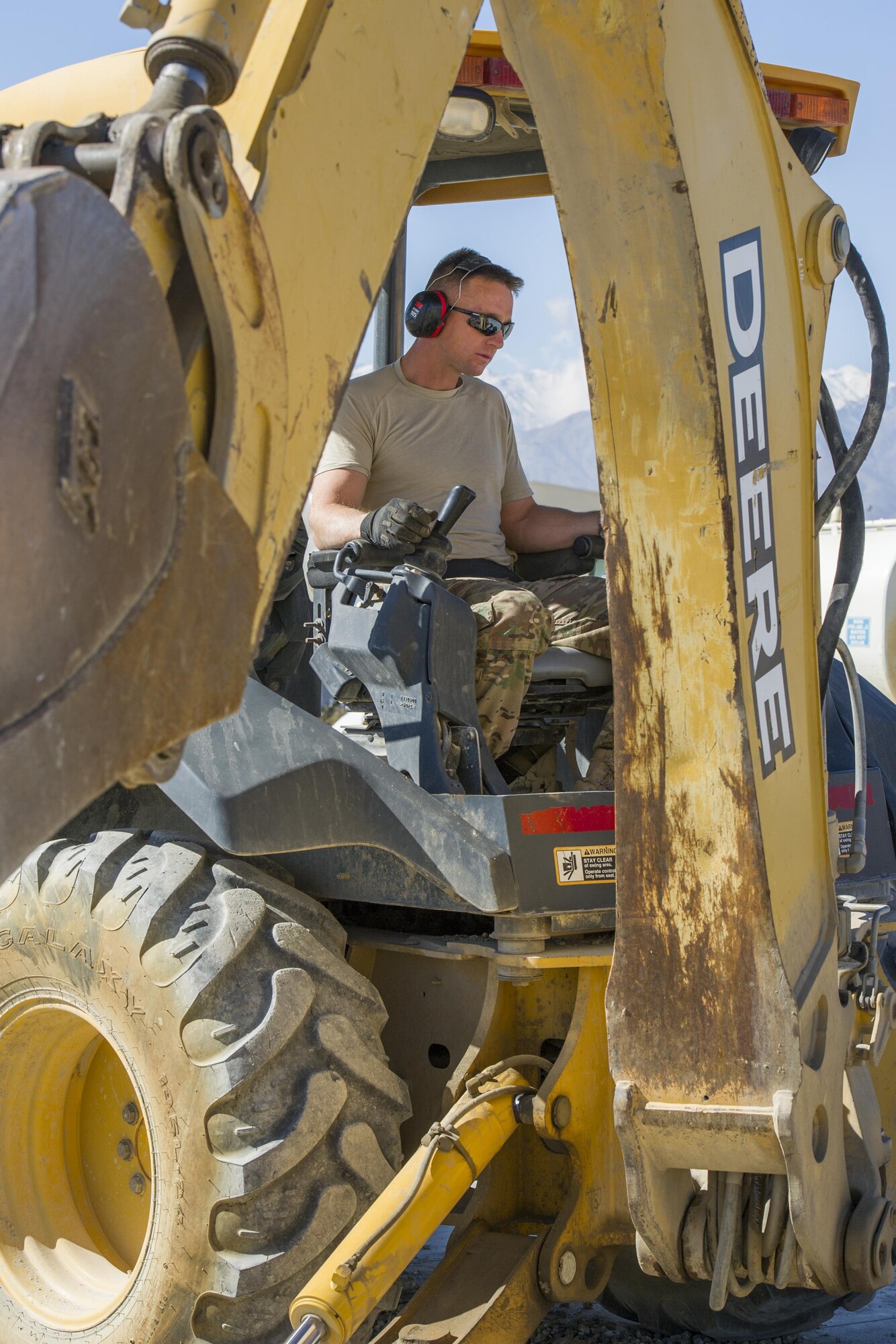 Tech. Sgt. David Blankenship, 455th Expeditionary Civil Engineer Squadron pavements and equipment technician, deployed from the 2nd CES at Barksdale Air Force Base, La., operates a backhoe at Bagram Airfield, Afghanistan, Nov. 4, 2015. The 455th ECES "Dirt Boys" prepared an area for cement to be poured in support of a large area maintenance structure slated for construction in the next few months.(U.S. Air Force photo by Tech. Sgt. Robert Cloys/RELEASED)