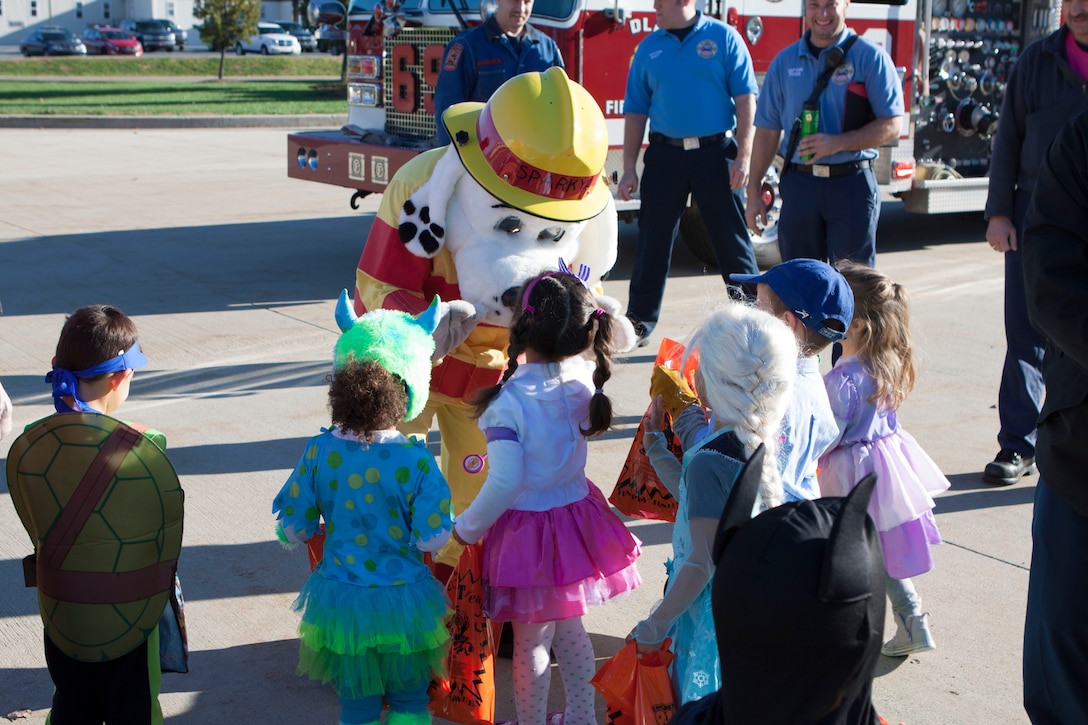Sparky the Fire Dog greets the children from the Child Development Center during the Oct. 30 parade at Defense Distribution Center, Susquehanna.