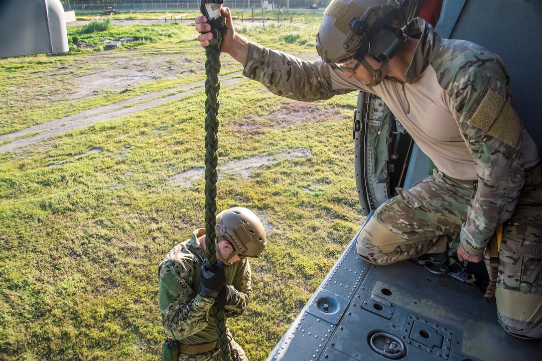 Sailors conduct helicopter rope-suspension technique training from a MH-60S Sea Hawk helicopter on Naval Base Guam, Oct. 29, 2015. The helicopter crew is assigned to Sea Combat Squadron 25. U.S. Navy photo by Petty Officer 2nd Class Daniel Rolston 