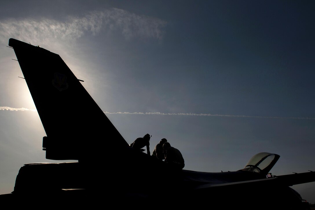U.S. airmen perform maintenance on an F-16 Fighting Falcon aircraft on Bagram Airfield, Afghanistan, Oct. 30, 2015. The airmen, assigned to the 455th Expeditionary Aircraft Maintenance Squadron, ensure Fighting Falcons on Bagram are prepared for flight and return them to a mission-ready state once they land. U.S. Air Force photo by Tech. Sgt. Joseph Swafford