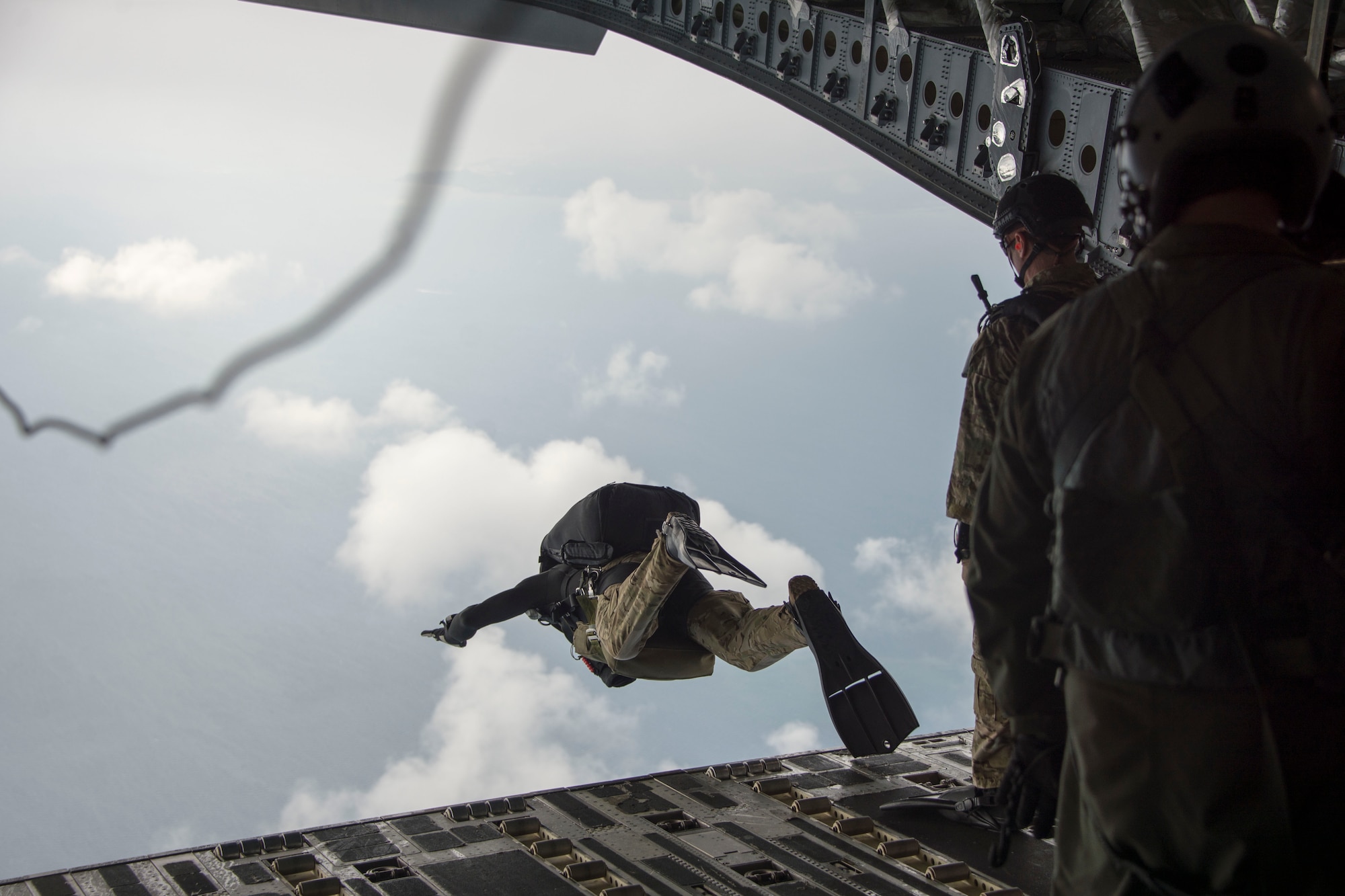 Master Sgt. Christopher Harding, a 212th Rescue Squadron pararescueman, performs a military free fall from a C-17 Globemaster from the 249th Airlift Squadron Oct. 31, 2015, near the coast of White Beach Naval Base, Japan. The aircraft airdropped an Alaska Air National Guard guardian angel rescue team along with two rescue crafts to conduct a long range search and rescue exercise. The C-17 also delivered an HH-60 Pave Hawk along with a maintenance crew to extract the team if needed. (Courtesy photo)