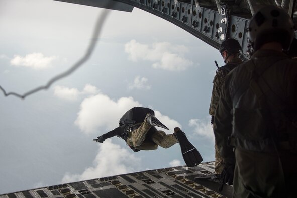 Master Sgt. Christopher Harding, a 212th Rescue Squadron pararescueman, performs a military free fall from a C-17 Globemaster from the 249th Airlift Squadron Oct. 31, 2015, near the coast of White Beach Naval Base, Japan. The aircraft airdropped an Alaska Air National Guard guardian angel rescue team along with two rescue crafts to conduct a long range search and rescue exercise. The C-17 also delivered an HH-60 Pave Hawk along with a maintenance crew to extract the team if needed. (Courtesy photo)