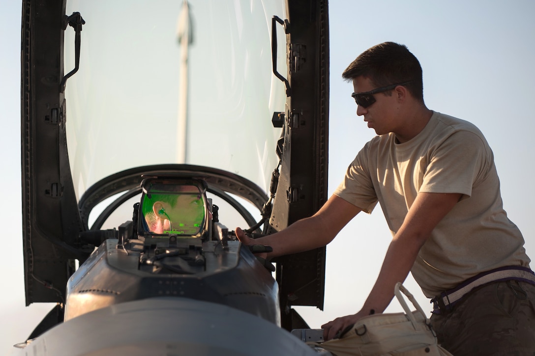 U.S. Air Force Capt. Tyler McBride, left, shakes hands with U.S. Air Force Airman 1st Class Christian Lamb before flying his first combat sortie in an F-16 Fighting Falcon on Bagram Air Field, Afghanistan, Oct. 30, 2015. Bride is a pilot assigned to the 421st Expeditionary Fighter Squadron and Lamb is a crew chief assigned to the 455th Expeditionary Aircraft Maintenance Squadron. U.S. Air Force photo by Tech. Sgt. Joseph Swafford