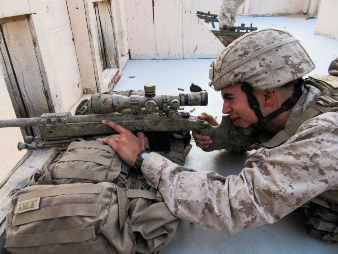 KUWAIT (Aug. 25, 2015) U.S. Marine Cpl. Mark Jerry fires an M40A5 sniper rifle during sustainment training. Jerry is a scout sniper with Weapons Company, Battalion Landing Team 3rd Battalion, 1st Marine Regiment, 15th Marine Expeditionary Unit. The Marines also practiced shooting and communicating while bounding in between barricades. (U.S. Marine Corps courtesy photo/Released)