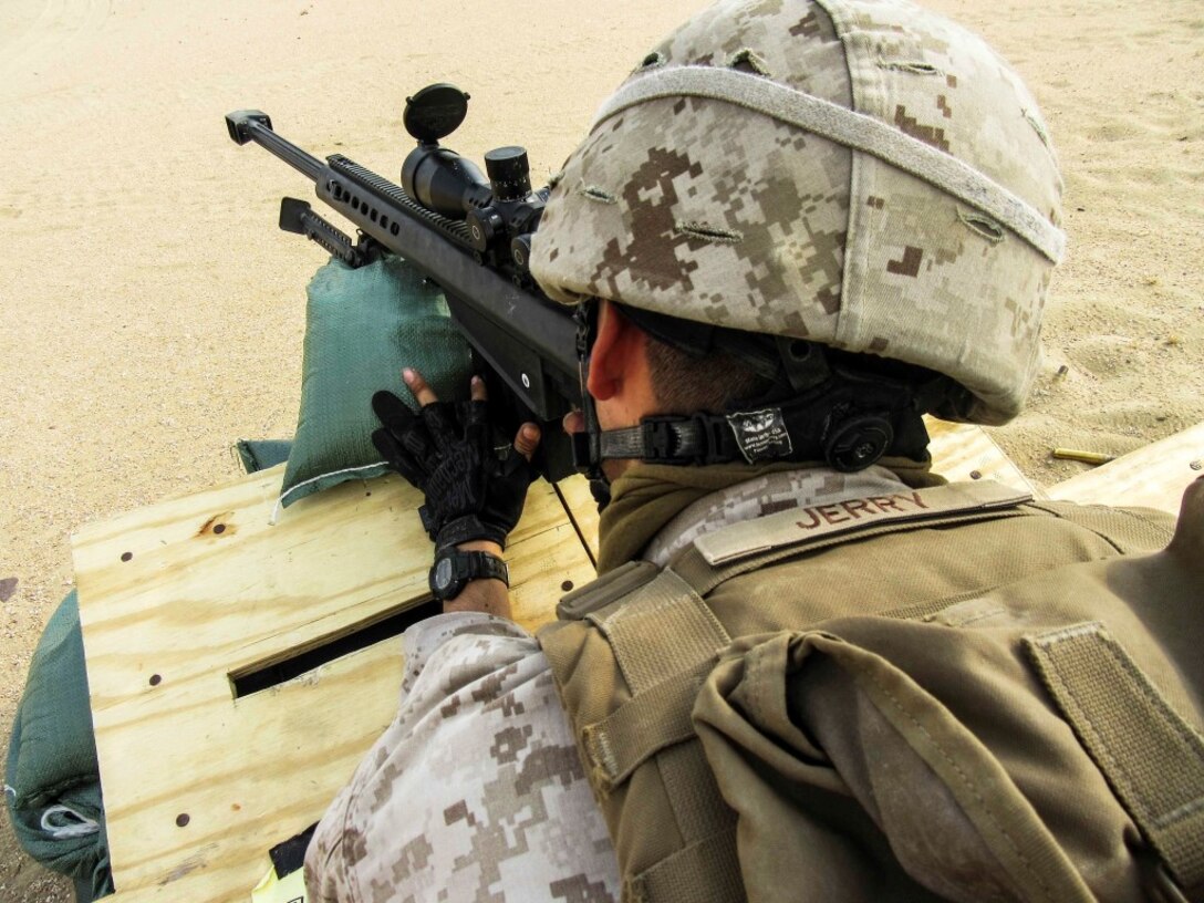 KUWAIT (Aug. 25, 2015) U.S. Marine Cpl. Mark Jerry fires an M107 Special Application Scope Rifle during sustainment training. Jerry is a scout sniper with Weapons Company, Battalion Landing Team 3rd Battalion, 1st Marine Regiment, 15th Marine Expeditionary Unit. The Marines also practiced shooting and communicating while bounding in between barricades. (U.S. Marine Corps courtesy photo/Released)