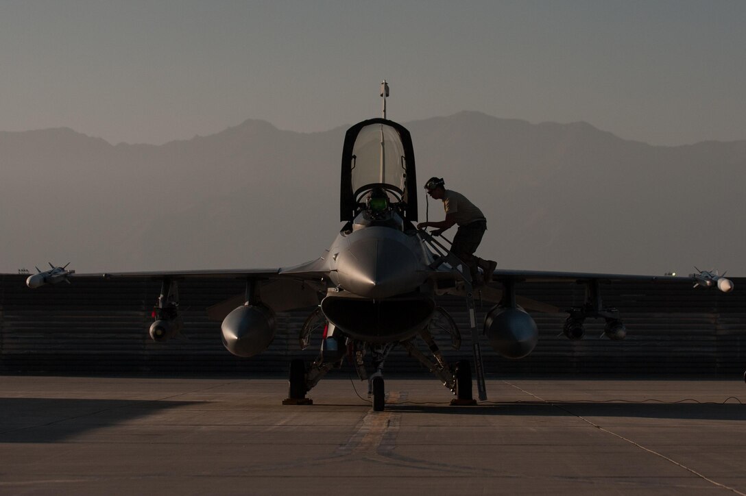 U.S. Air Force Airman 1st Class Christian Lamb goes over last minute checks before a combat sortie on Bagram Airfield, Afghanistan, Oct. 30, 2015. Lamb is a crew chief assigned to the 455th Expeditionary Aircraft Maintenance Squadron. U.S. Air Force photo by Tech. Sgt. Joseph Swafford