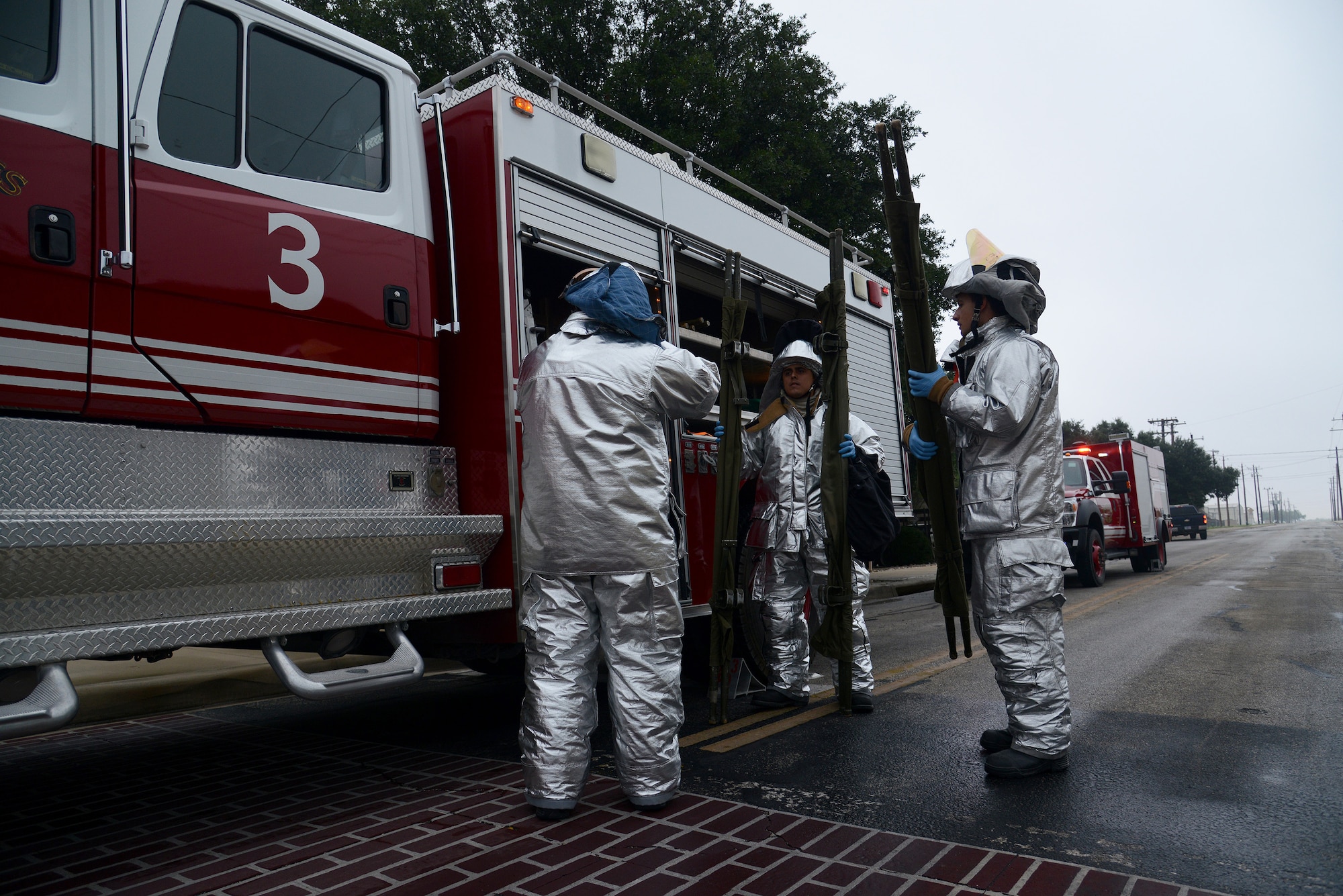 Firefighters with the 47th Civil Engineer Squadron prepare litter carriers during a two-day exercise on Laughlin Air Force Base, Texas, Oct. 30, 2015.  Day two of the exercise involved simulating an aircraft hijacking and active shooter scenario with multiple “victims.” (U.S. Air Force photo by Airman 1st Class Ariel D. Partlow)(Released)