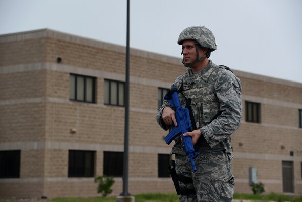 Staff Sgt. Matthew Solis, 47th Security Forces Squadron reports and analysis, cordons a simulated crime scene on Laughlin Air Force Base, Texas, Oct. 30, 2015. The exercises involved a simulated aircraft hijack and an active shooter scenario, a combined force protection condition, and an anti-terrorism and chemical, biological, radiological, nuclear and explosives scenario. (U.S. Air Force photo by Airman 1st Class Ariel D. Partlow)(Released)