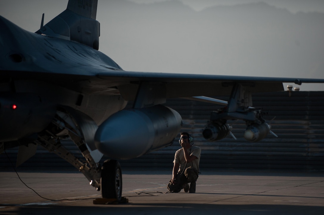 U.S. Air Force Airman 1st Class Christian Lamb conducts a preflight inspection on an F-16 Fighting Falcon aircraft on Bagram Airfield, Afghanistan, Oct. 30, 2015. Lamb is a crew chief assigned to the 455th Expeditionary Aircraft Maintenance Squadron. U.S. Air Force photo by Tech. Sgt. Joseph Swafford