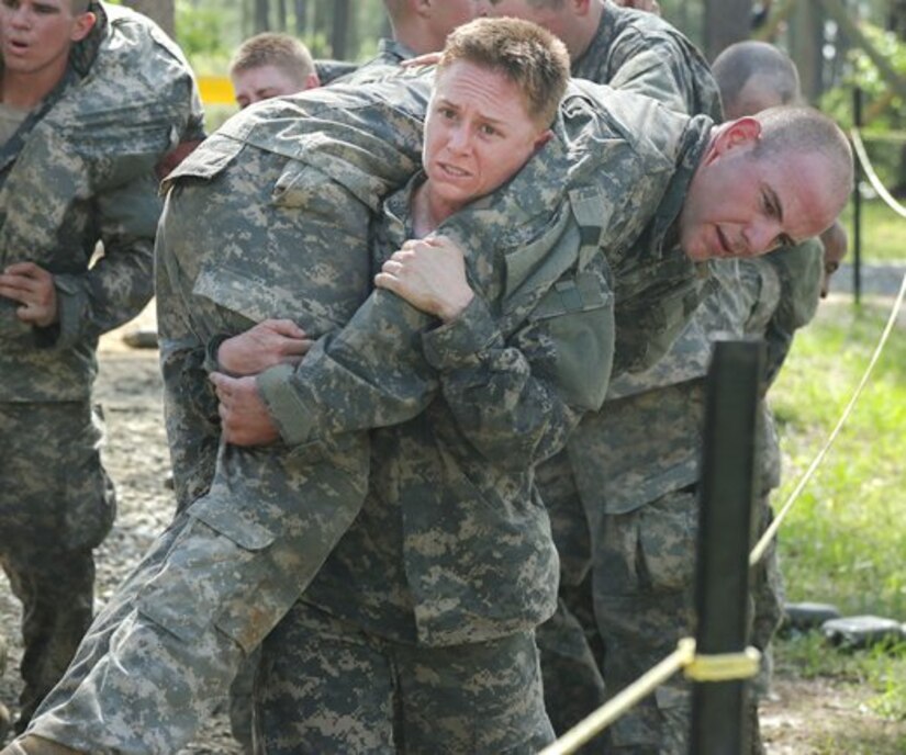 Maj. Lisa Jaster, an Individual Mobilization Augmentee officer, who serves with the U.S. Army Engineering and Support Center, carries a fellow Soldier during the Darby Queen obstacle course segment of the Ranger course on Fort Benning, Ga., April 26, 2015.