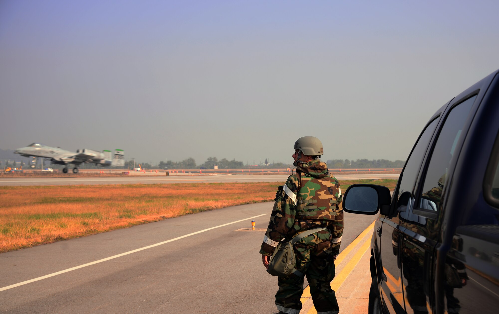 Staff Sgt. David Morales, 51st Operations Support Squadron airfield management operations supervisor, monitors the flightline while an A-10 Thunderbolt II assigned to the 25th Fighter Squadron lands Nov. 3, 2015, at Osan Air Base, Republic of Korea. Morales is responsible for ensuring the flightline is operational for every aircraft participating in the peninsula-wide readiness exercise Vigilant Ace 16. Vigilant Ace 16 is a large-scale exercise designed to enhance the interoperability of the U.S. and Republic of Korea Air Forces. (U.S. Air Force photo/Staff Sgt. Benjamin Sutton)