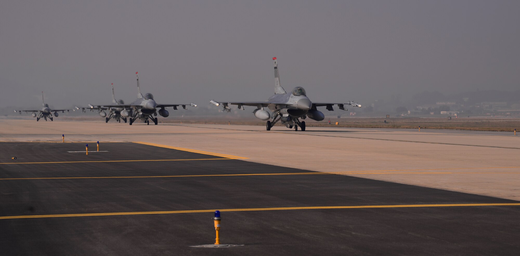 F-16 Fighting Falcons assigned to the 36th Fighter Squadron taxi along the runway Nov. 3, 2015, at Osan Air Base, South Korea. Airfield managers from the 51st Operations Support Squadron ensure the flightline is operational for these aircraft while participating in readiness exercise Vigilant Ace 16, a large-scale exercise designed to test the combat capabilities and enhance the interoperability of the U.S. and South Korean air forces. (U.S. Air Force photo/Staff Sgt. Benjamin Sutton)