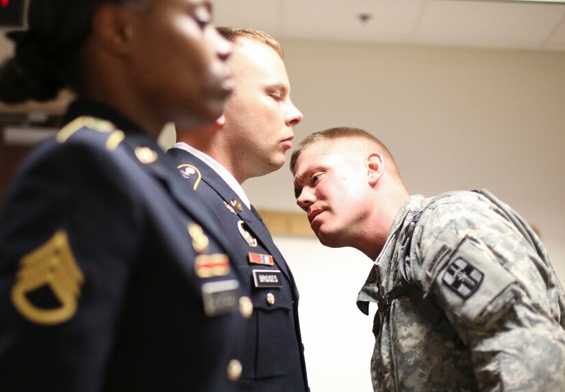 Staff Sgt. Andrew Fink, 807th Medical Command (Deployment Support), is tested on the Army Service Uniform's proper wear during the 2015 U.S. Army Reserve Best Warrior Competition at Fort Bragg, N.C., May 6. Each competitor was to spot any and all discrepancies on the uniform for both male and female in three minutes. This year's Best Warrior competition will determine the top noncommissioned officer and junior enlisted Soldier who will represent the Army Reserve in the Department of the Army Best Warrior competition later this year at Fort Lee, Va. (U.S. Army photo by Staff Sgt. Sharilyn Wells/Released)