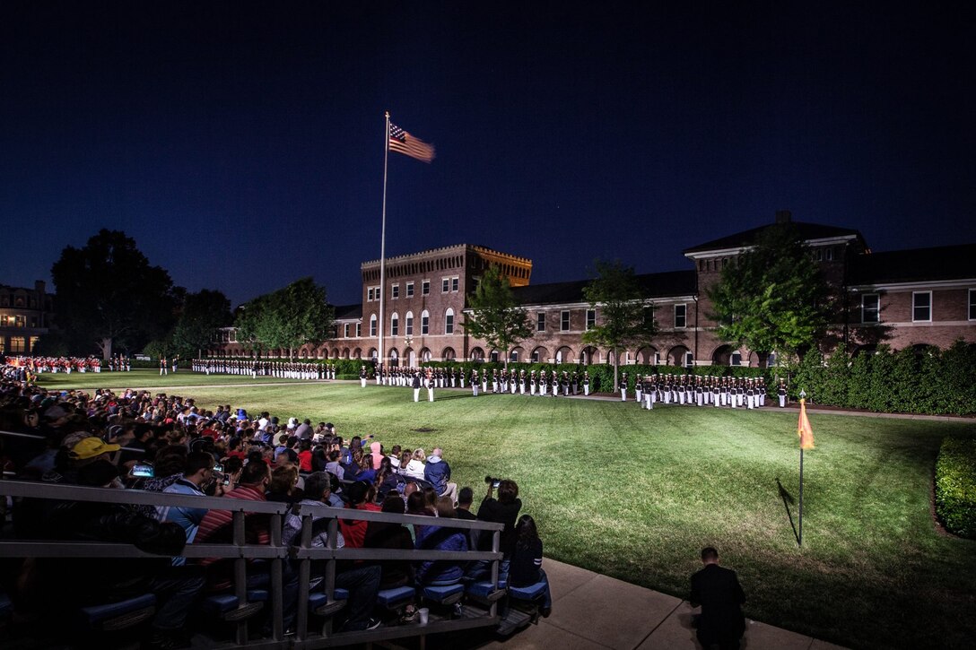 An Evening Parade is held at Marine Barracks Washington, D.C., May 22, 2015. . The Evening Parade summer tradition began in 1934 and features the Silent Drill Platoon, the U.S. Marine Band, and the U.S. Marine Drum and Bugle Corps, and two marching companies. More than 3,500 guests attend the parade every week. (U.S. Marine Corps photo by Sgt. Melissa Marnell/Released)