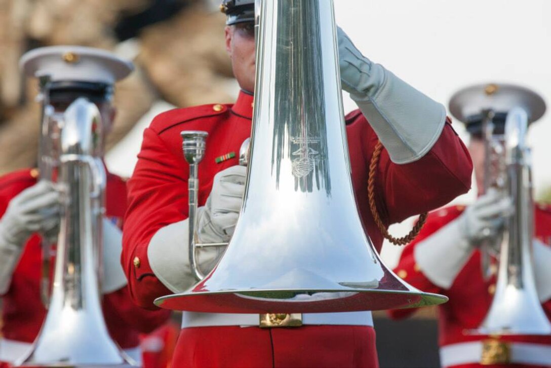 U.S. Marines with the U.S. Marine Corps Drum and Bugle Corps perform during the evening parade at the Marine Corps War Memorial, Arlington, Va., May 26, 2015.Since September 1956, marching and musical units from Marine Barracks Washington, D.C., have been paying tribute to those whose “uncommon valor was a common virtue” by presenting sunset parades in the shadow of the 32-foot high figures of the United States Marine Corps War Memorial. (U.S. Marine Corps photo by Lance Cpl. Alejandro Sierras/Released)