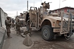 Citizen-Soldiers from the 156th Military Police Detachment, attached to the 1st Air Cavalry Brigade, 1st Cavalry Division, exit their mine-resistant, ambush-protected, all-terrain vehicle outside the Balkh provincial prison in Afghanistan, Oct. 23, 2011. Soldiers of the 156th MP were at the prison in order to fulfill one of their many mission sets by enrolling the local Afghan national prisoners into a biometric system, enabling Coalition and Afghan forces to create a viable database in order to forensically identify criminals.