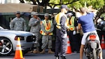 Hawaii Army National Guard soldiers augment the Honolulu Police Department's security and traffic control teams in Waikiki during the Asia Pacific Economic Cooperation Summit in November of 2011.