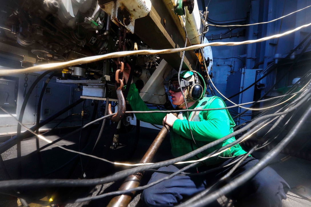 U.S. Navy Seaman Recruit Joseph Hayden performs a test cell run on a GE-414 jet engine aboard the aircraft carrier USS Theodore Roosevelt in the Sulu Sea, Nov. 1, 2015. The carrier is operating in the U.S. 7th Fleet area of operations as part of a worldwide deployment en route to its new homeport in San Diego. U.S. Navy photo by Petty Officer 3rd Class Stephane Belcher