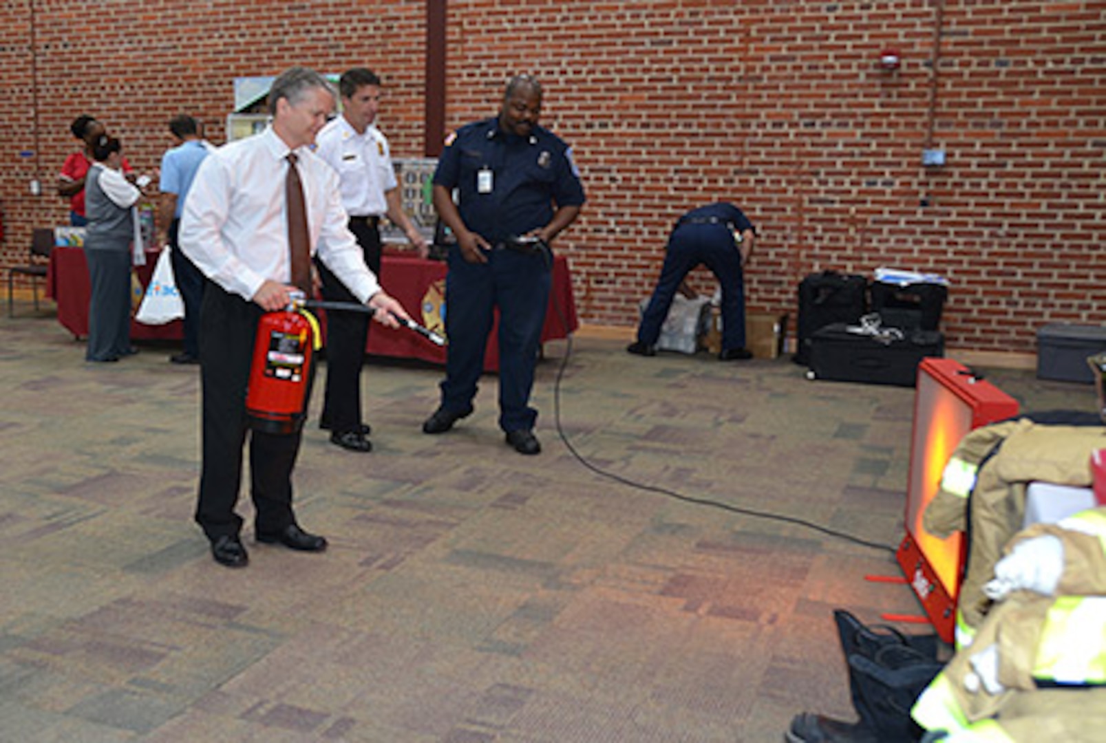 Defense Logistics Agency Installation Support at Richmond’s Site Director David Gibson practices using a simulated fire extinguisher to put out a fire during the installation’s National Preparedness Fair Sept. 22, 2015 in the Lotts Conference Center on Defense Supply Center Richmond, Virginia. 