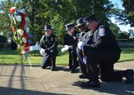 Defense Logistics Agency Installation Support at Richmond, Virginia held a 9-11 Remembrance Ceremony on the lawn of the DLA Aviation Headquarters Building on Defense Supply Center Richmond Sept. 11, 2015. After the ceremony the four DLA police and firefighters who served on the honor guard during the event, reflect and pray in front of wreath that was placed at flagpole, paying homage to fallen police, firefighters and emergency police who lost their lives on Sept. 11, 2001.   