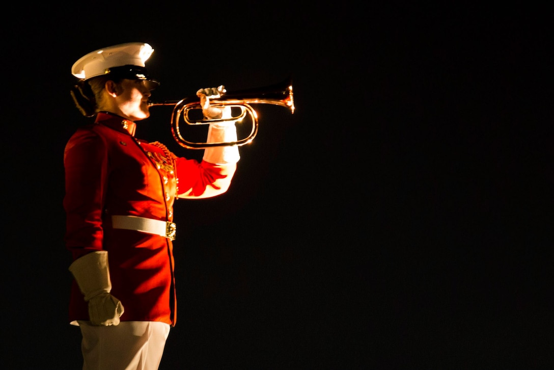 Ceremonial Bugler, Staff Sergeant Codie Williams, performs Taps in conclusion to the Evening Parade at Marine Barracks Washington, D.C., June 12. (Official Marine Corps photo by Cpl. Chi Nguyen/Released)