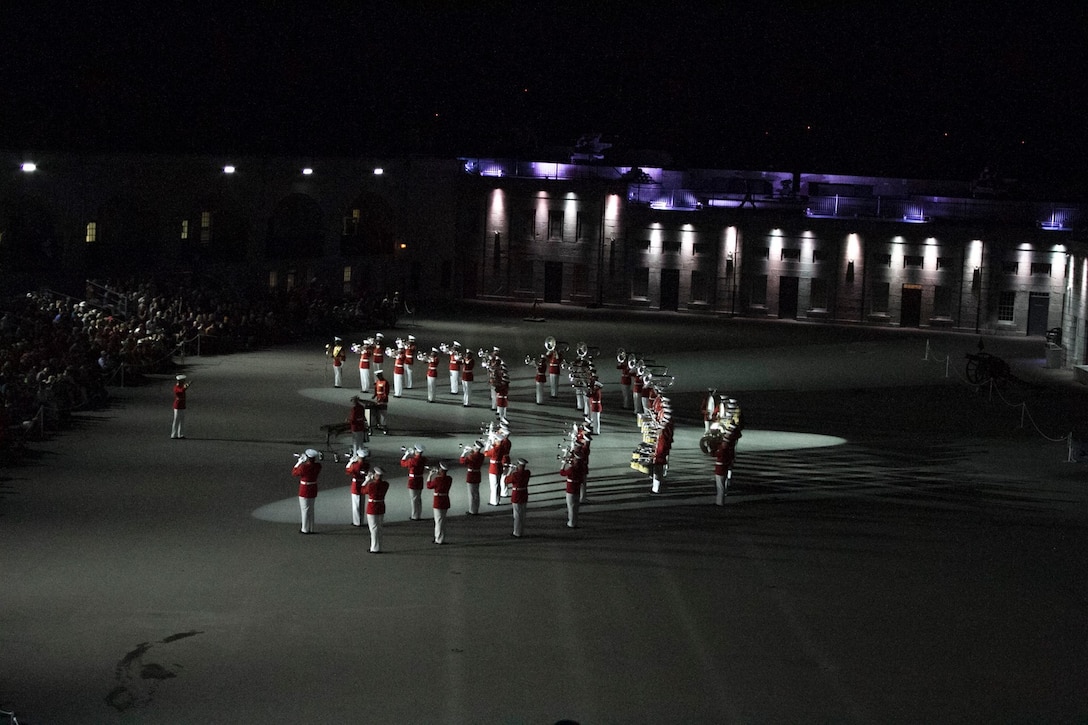 The United States Marine Drum and Bugle Corps performs as part of a joint ceremony with the Fort Henry Guard located at Fort Henry, Kingston, Ontario. This visit marked the anniversary of the Ogdensburg Agreement, which was signed by President Roosevelt and Prime Minister King to bind the two nations in the joint defense of North America. (U.S. Marine Corps photo by Cpl. Skye Davis/Released) 