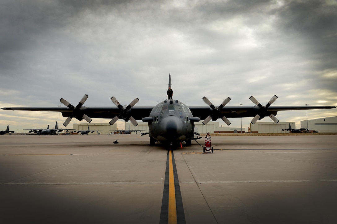 An aircrew member conducts a pre-flight inspection of "Heavy Metal," an AC-130H Spectre gunship, April 8, 2015, at Cannon Air Force Base, N.M. U.S. Air Force photo by Staff Sgt. Matthew Plew