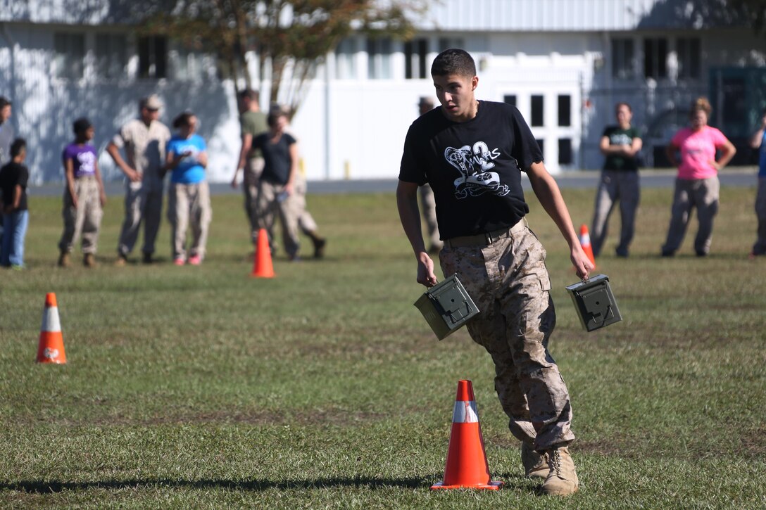 Giavante, 17, maneuvers through a Combat Fitness Test during the Marine Wing Headquarters Squadron 2’s Warrior Day at Marine Corps Air Station Cherry Point, N.C., Oct.30, 2015. Marines with MWHS-2 hosted an interactive day where families could participate in some of the routine training Marines undergo. Family members had the opportunity to fire in a simulated range, experience night vision equipment, partake in a CFT, receive a Marine Corps Martial Arts Program class and brave the obstacle course. Mathieu is the brother of Cpl. Raquel Mathieu, an intelligence specialist with the squadron. (U.S. Marine Corps photo by Cpl. N.W. Huertas/ Released)