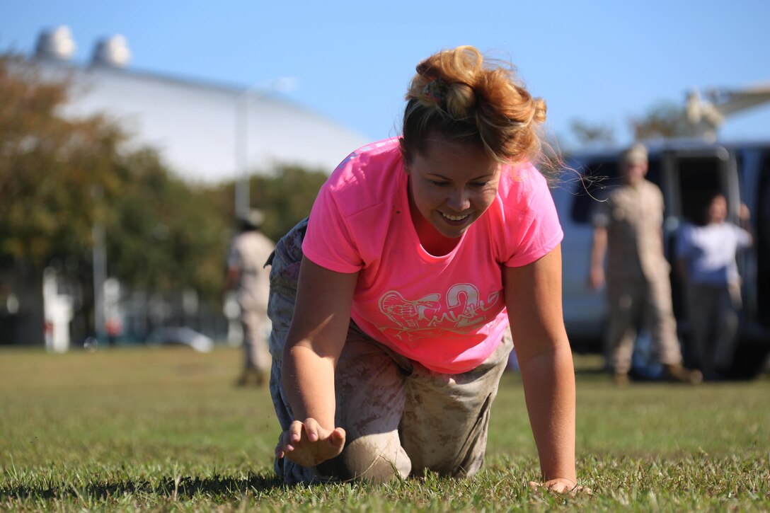 Cassie Johnson maneuvers through a Combat Fitness Test during the Marine Wing Headquarters Squadron 2’s Warrior Day at Marine Corps Air Station Cherry Point, N.C., Oct.30, 2015. Marines with MWHS-2 hosted an interactive day where families could participate in some of the routine training Marines undergo. The CFT is a yearly evaluation of Marines combat oriented fitness. Johnson is the spouse of Sgt. Nathan Johnson, a trumpet player with the 2nd MAW band. (U.S. Marine Corps photo by Cpl. N.W. Huertas/ Released)