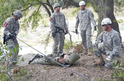 Competitors in the 2015 Army Best Medic Competition at Fort Sam Houston and Camp Bullis prepare to evacuate a patient in a rough terrain exercise requiring repel techniques using a field litter. The competition took place from Oct. 27 through Friday.