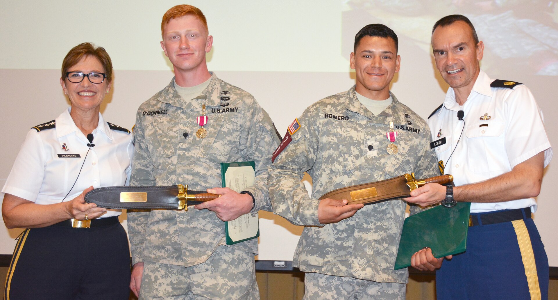 Lt. Gen. Patricia Horoho (left), commanding general, U.S. Army Medical Command and U.S. Army Surgeon General, and MEDCOM Command Sgt. Maj. Gerald C. Ecker (right), congratulate Spc. Collin O’Donnell and Spc. Jesus Romero, 173rd Airborne Brigade, Vicenza, Italy, the first-place winners of the 2015 Army Best Medic Competition at an awards ceremony at Blesse Auditorium, Willis Hall, U.S. Army Medical Department Center and School Friday. O’Donnell and Romero each received the Army Meritorious Service Medal, a MEDCOM coin and a replica of the medical corps field knife. The competition was held Oct. 27 through Friday at Fort Sam Houston and Camp Bullis. 
