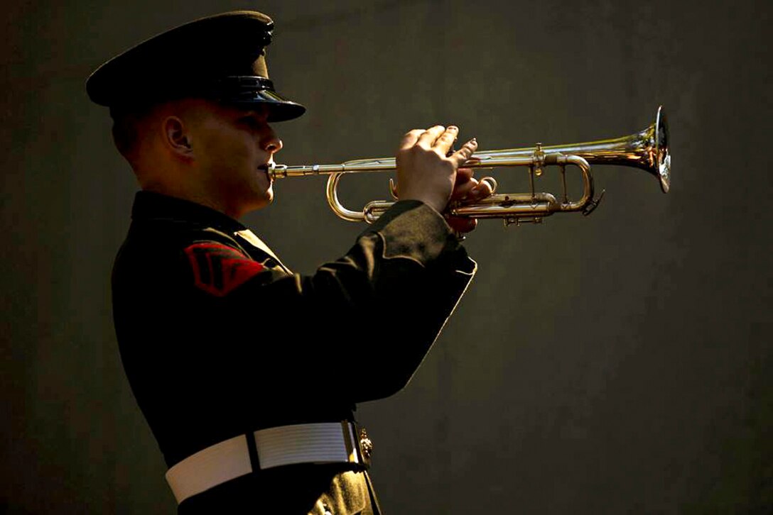 Marine Corps Cpl. Derek Detzler performs taps during the 32nd Beirut Memorial Observance Ceremony in Jacksonville, N.C., Oct. 23, 2015. The event honored the service members killed in the 1983 Marine Barracks bombing in Beirut, Lebanon. Detzler is a bugler with the 2nd Marine Division Band. U.S. Marine Corps photo by Cpl. Todd F. Michalek
