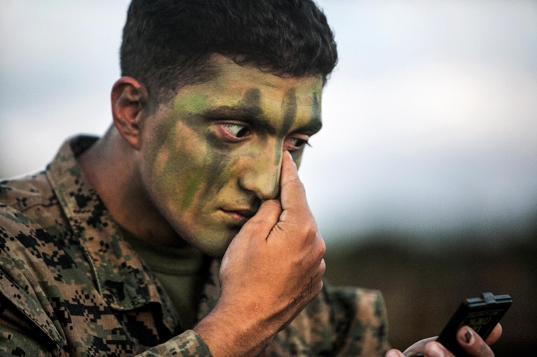 U.S. Marine Corps Cpl. Michael B. Wheeler applies camouflage paint on Camp Hansen, Okinawa, Japan, Oct. 31, 2015, to prepare for a regimental air assault during Blue Chromite 2016. The large-scale amphibious exercise draws primarily from the 3rd Marine Expeditionary Force’s training resources on Okinawa. U.S. Marine Corps photo by Cpl. Drew Tech