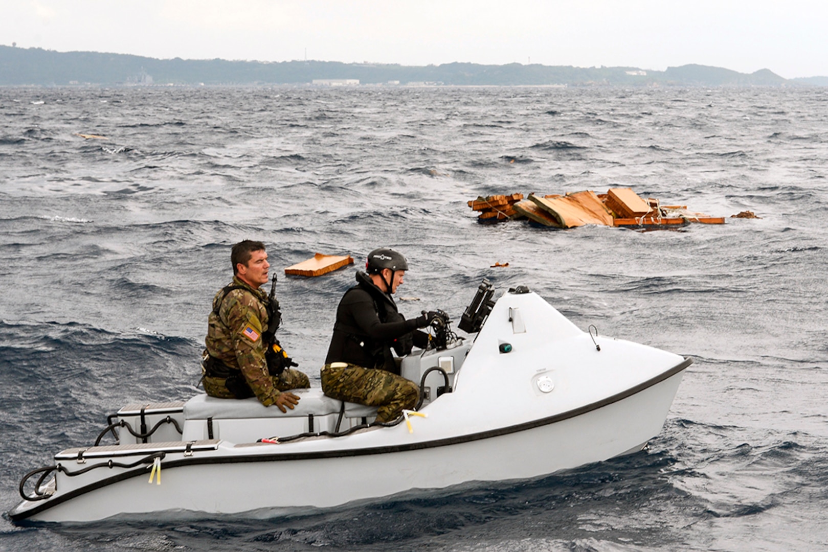 U.S. Air Force Master Sgt. Shane Hargis, Alaska Air National Guard’s 212th Rescue Squadron pararescueman, and Maj. Jay Casello, 212th RQS combat rescue officer, begin a mock search for survivors aboard a Guardian Angel rescue craft Oct. 31, 2015, near the coast of White Beach Naval Base, Japan. The rescue team was airdropped by a C-17 Globemaster from Alaska ANG’s 249th Airlift Squadron in a long range search and rescue exercise. 