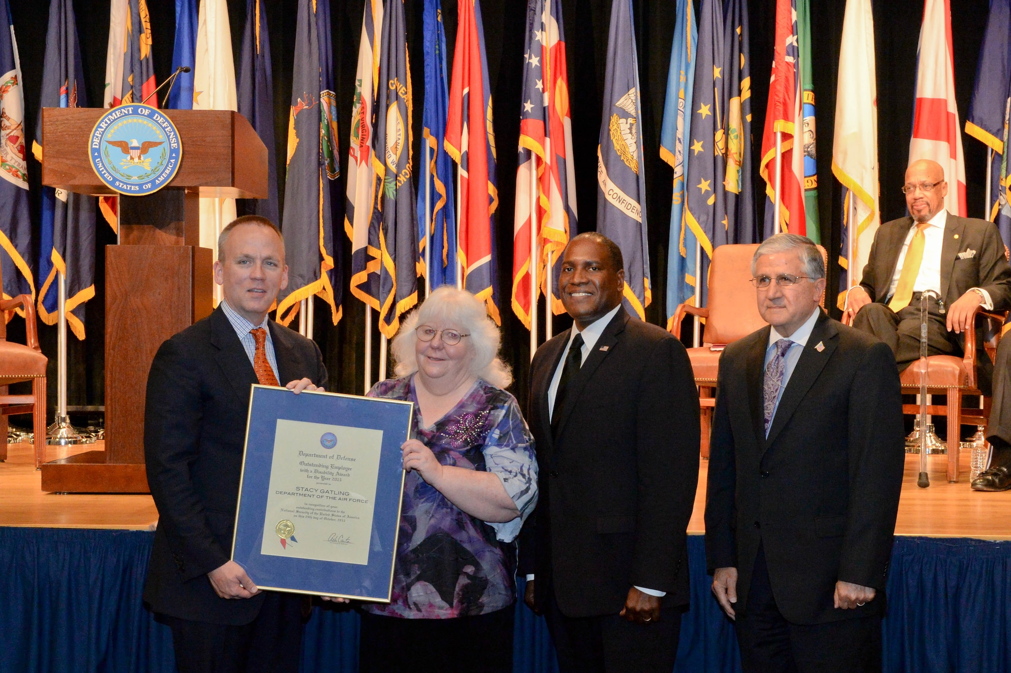 Brad Carson, the acting undersecretary of defense for personnel and readiness, presents Stacy Gatling, the Directed Energy Directorate executive secretary at the Air Force Research Laboratory on Kirtland Air Force Base, N.M., with a secretary of defense award to outstanding civilian and service members with disabilities during a ceremony at the Pentagon Oct. 29, 2015. (U.S. Army photo/Sgt. Courtney Russell)