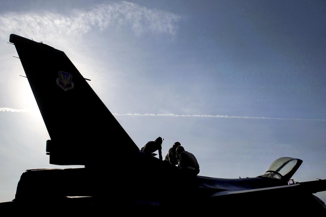 U.S. airmen perform maintenance on an F-16 Fighting Falcon aircraft on Bagram Airfield, Afghanistan, Oct. 30, 2015. The airmen, assigned to the 455th Expeditionary Aircraft Maintenance Squadron, ensure Fighting Falcons on Bagram are prepared for flight and return them to a mission-ready state once they land. U.S. Air Force photo by Tech. Sgt. Joseph Swafford