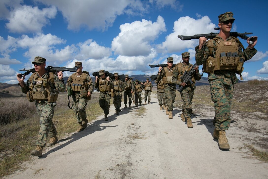 U.S. Marines with 11th Marine Expeditionary Unit (11th MEU) carry M240B machine guns and M249 light machine guns from a firing range after crew served weapons training at Camp Pendleton, Calif., Nov. 3, 2015. Crew served weapons training develops Marines efficiency with the M240B machine gun and M249 light machine gun and reinforces combat readiness. (U.S. Marine Corps photo by Cpl. Xzavior T. McNeal)