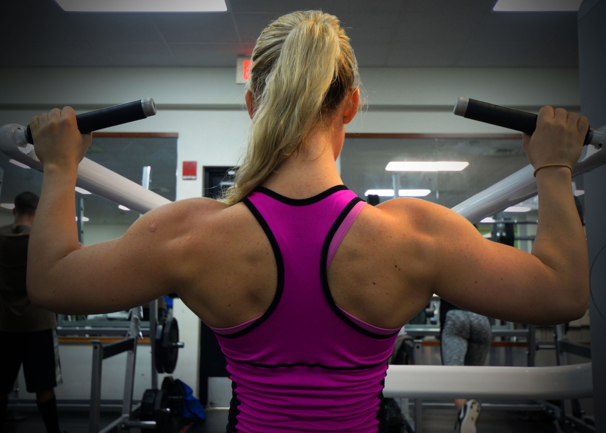 Senior Airman Kelly Berger, 36th Civil Engineer Squadron pest management journeyman, performs a lat pulldown Oct. 2, 2015, at Andersen Air Force Base, Guam.  In September, Berger competed in and placed first in her division in the 2015 Guam National Fitness Championships and International Invitational. (U.S. Air Force photo by Senior Airman Joshua Smoot/Released)