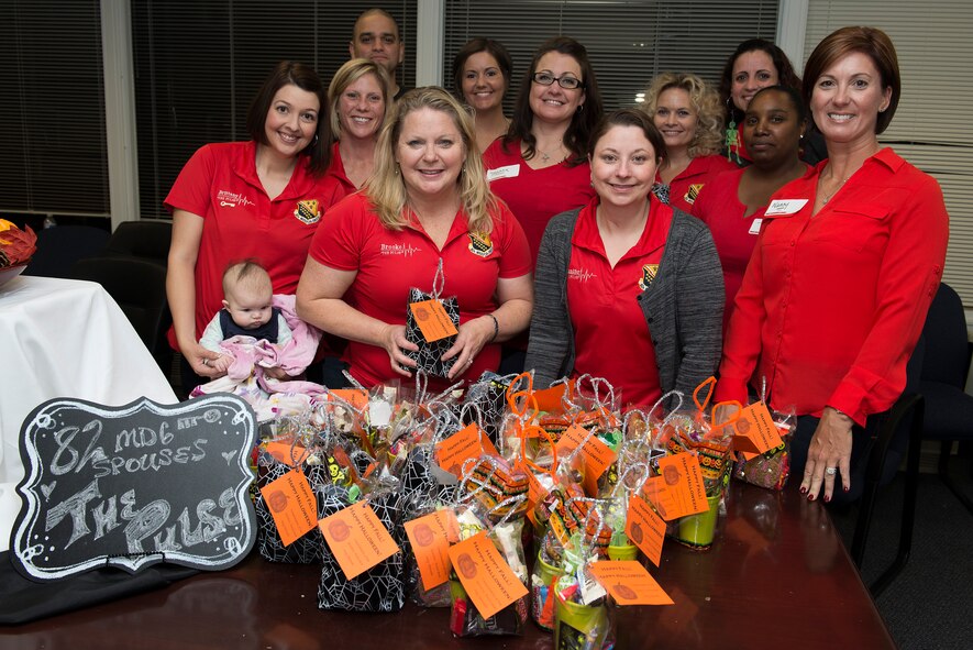 82nd Medical Group Key Spouses pause for a photo after preparing gift bags for Airmen that live in the MDG dorms at Sheppard Air Force Base, Texas, Oct. 27, 2015. The Key Spouse program is a formal commander driven unit and family program with the mission to enhance readiness and establish a sense of Air Force community. (U.S. Air Force photo/Senior Airman Kyle Gese)