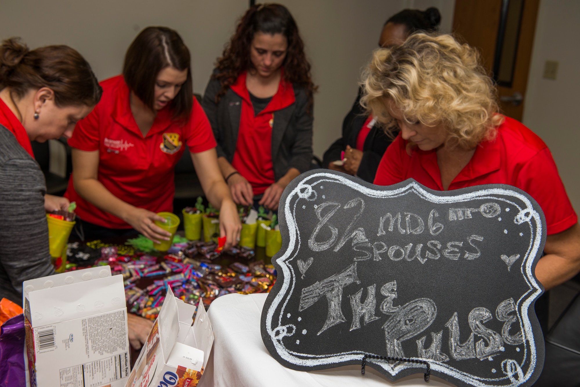 82nd Medical Group Key Spouses fill gift bags for Airmen that live in the MDG dorms at Sheppard Air Force Base, Texas, Oct. 27, 2015. The Key Spouse program is a formal commander driven unit and family program with the mission to enhance readiness and establish a sense of Air Force community. (U.S. Air Force photo/Senior Airman Kyle Gese)