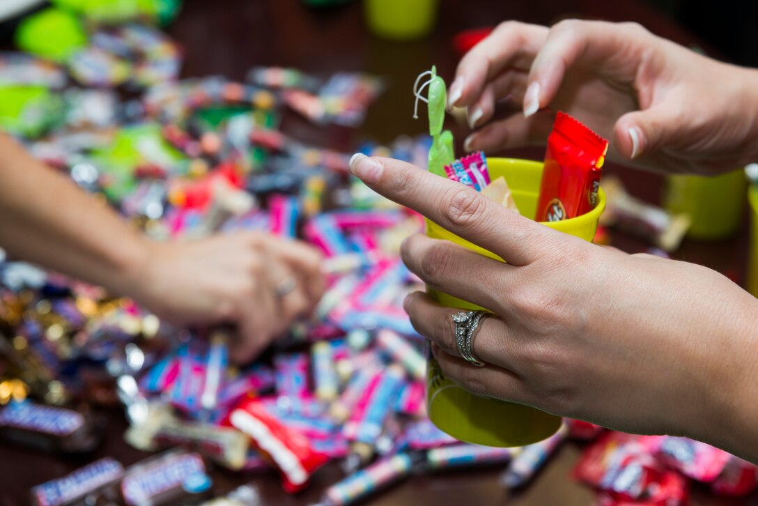 82nd Medical Group Key Spouses fill gift bags for Airmen that live in the MDG dorms at Sheppard Air Force Base, Texas, Oct. 27, 2015. The Key Spouse program is a formal commander driven unit and family program with the mission to enhance readiness and establish a sense of Air Force community. (U.S. Air Force photo/Senior Airman Kyle Gese)