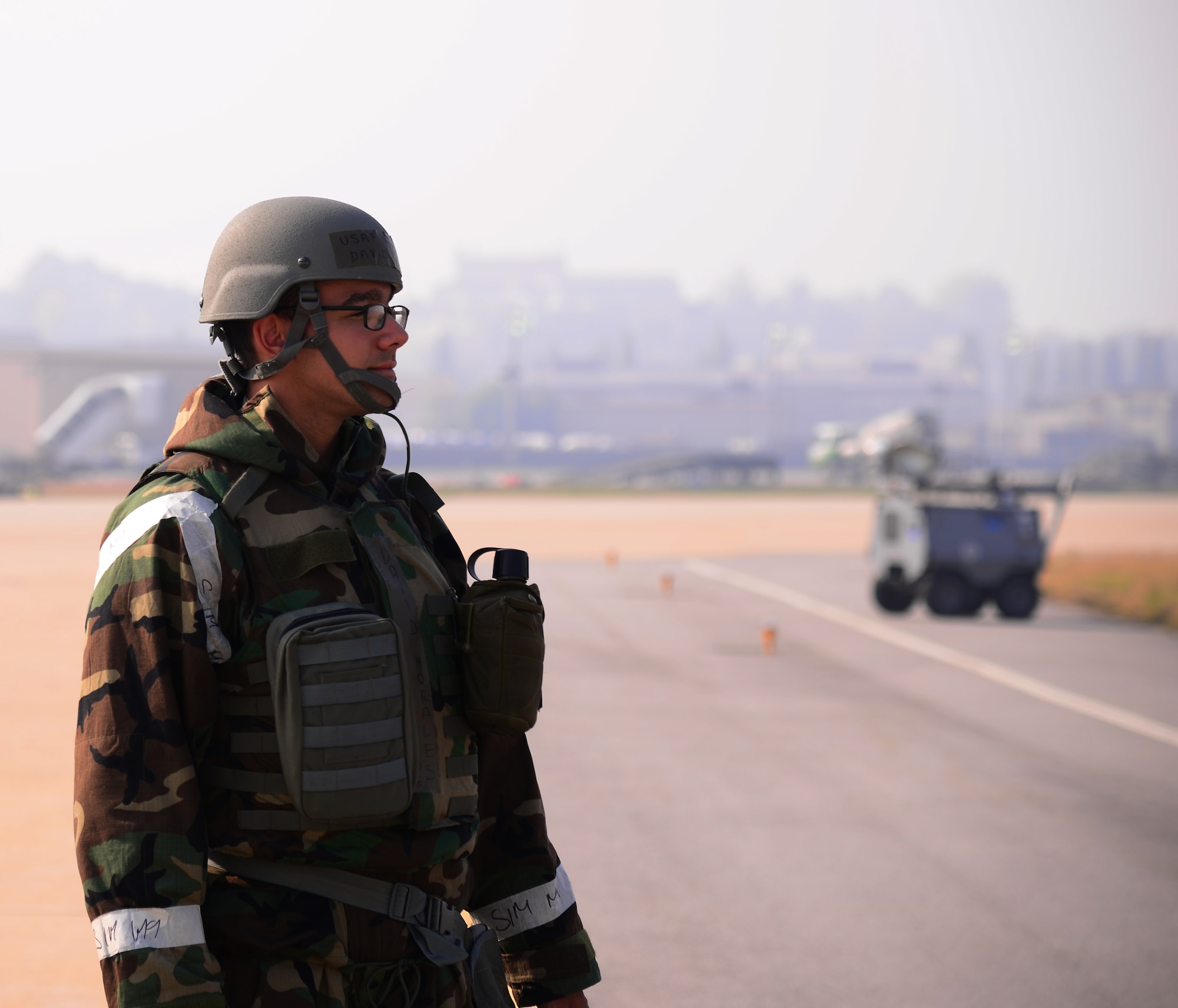 Staff Sgt. David Morales, 51st Operations Support Squadron airfield management operations supervisor, watches a jet land on flightline Nov. 3, 2015, at Osan Air Base, Republic of Korea. Morales and more than 16,000 other personnel are participating in readiness exercise Vigilant Ace 16. Vigilant Ace 16 is a large-scale exercise designed to test the combat capabilities and enhance the interoperability of the U.S. and Republic of Korea Air Forces. (U.S. Air Force photo/Staff Sgt. Benjamin Sutton)