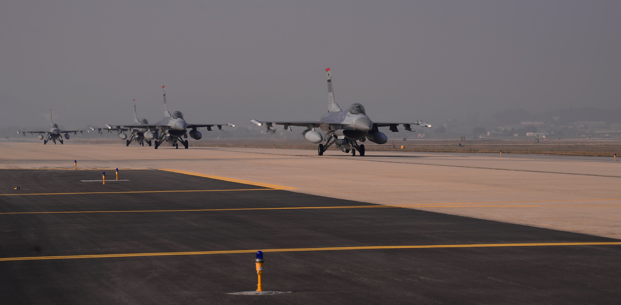 F-16 Fighting Falcons assigned to the 36th Fighter Squadron taxi along the runway Nov. 3, 2015, at Osan Air Base, Republic of Korea. Airfield managers from the 51st Operations Support Squadron ensure the flightline is operational for these aircraft while participating in readiness exercise Vigilant Ace 16, a large-scale exercise designed to test the combat capabilities and enhance the interoperability of the U.S. and Republic of Korea Air Forces. (U.S. Air Force photo/Staff Sgt. Benjamin Sutton)