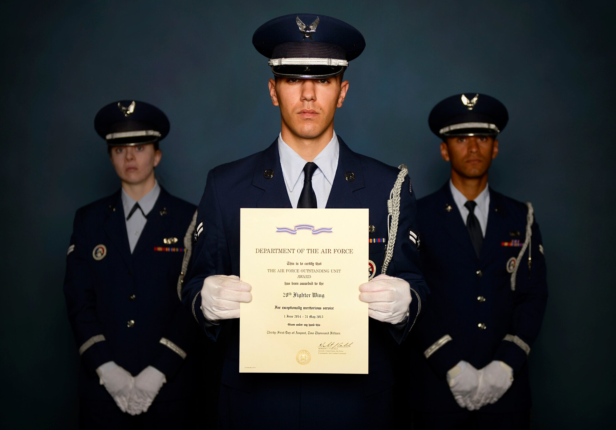 U.S. Air Force Airmen assigned to the 20th Force Support Squadron honor guard, stand with the Air Force Outstanding Unit Award at Shaw Air Force Base, S.C., Oct. 26, 2015. On Aug. 31, the 20th Fighter Wing received the award for exceptionally meritorious service from June 1, 2014 to May 31, 2015. Awarded by the secretary of the Air Force, the Air Force Outstanding Unit Award is given to units that have distinguished themselves through outstanding achievement that clearly sets the unit above national or international significance, combat operations against an armed enemy of the United States, or military operations involving conflict with or exposure to hostile actions by an opposing foreign force. (U.S. Air Force photo by Senior Airman Jensen Stidham/Released)