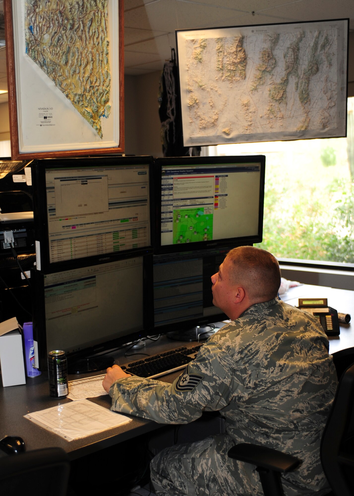 U.S. Air Force Tech. Sgt. Matthew Ordorff, 25th Operational Weather Squadron shift supervisor, reviews a weather forecast at Davis-Monthan Air Force Base, Ariz., Oct. 29, 2015. The 25th OWS Airmen complete three 30-hour forecasts daily while continuously watching for approaching weather threats. (U.S. Air Force photo by Airman Basic Nathan H. Barbour/Released)