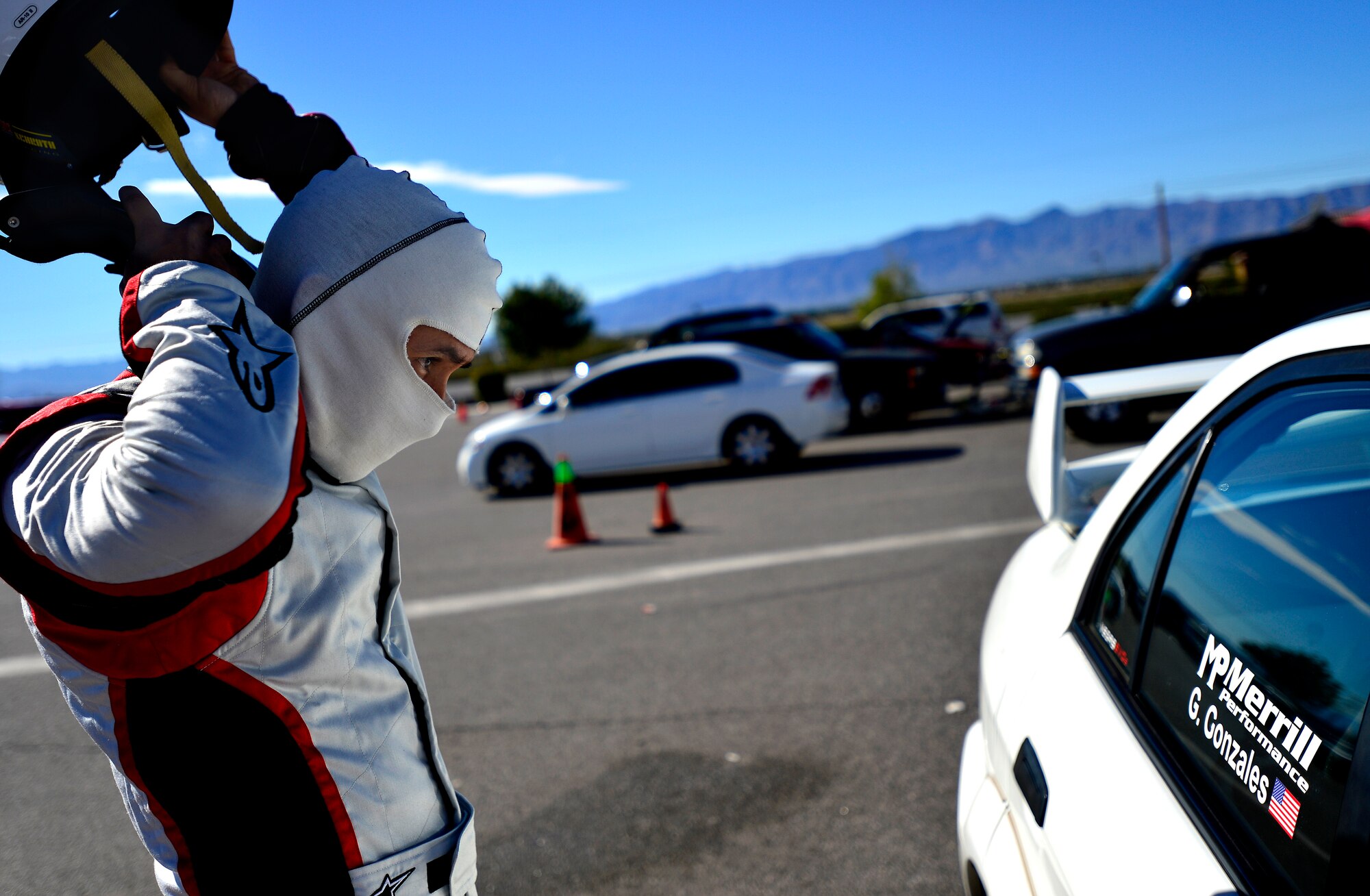 Tech. Sgt. Gabriel, 432nd Wing/432nd Air Expeditionary Wing MQ-9 Reaper sensor operator takes his helmet off after racing at the Spring Mountain Raceway Nov. 1, 2015, in Pahrump, Nevada. Gabriel participated in the race as part of the Redline Time Attack series which puts races in different class against the clock to see who can get the fastest time. Gabriel placed second in second highest class. (U.S. Air Force photo by Airman 1st Class Christian Clausen/Released)